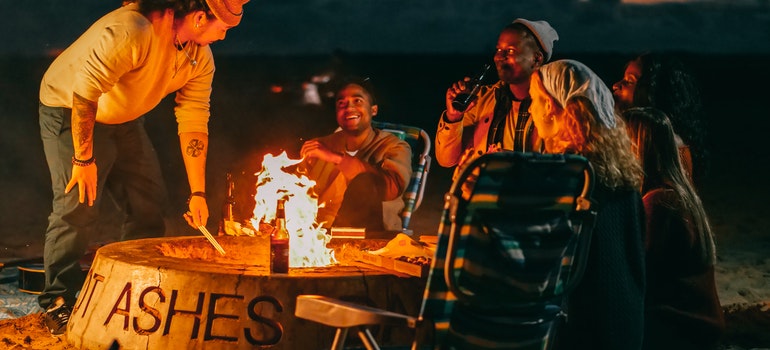People enjoying company around a fire pit